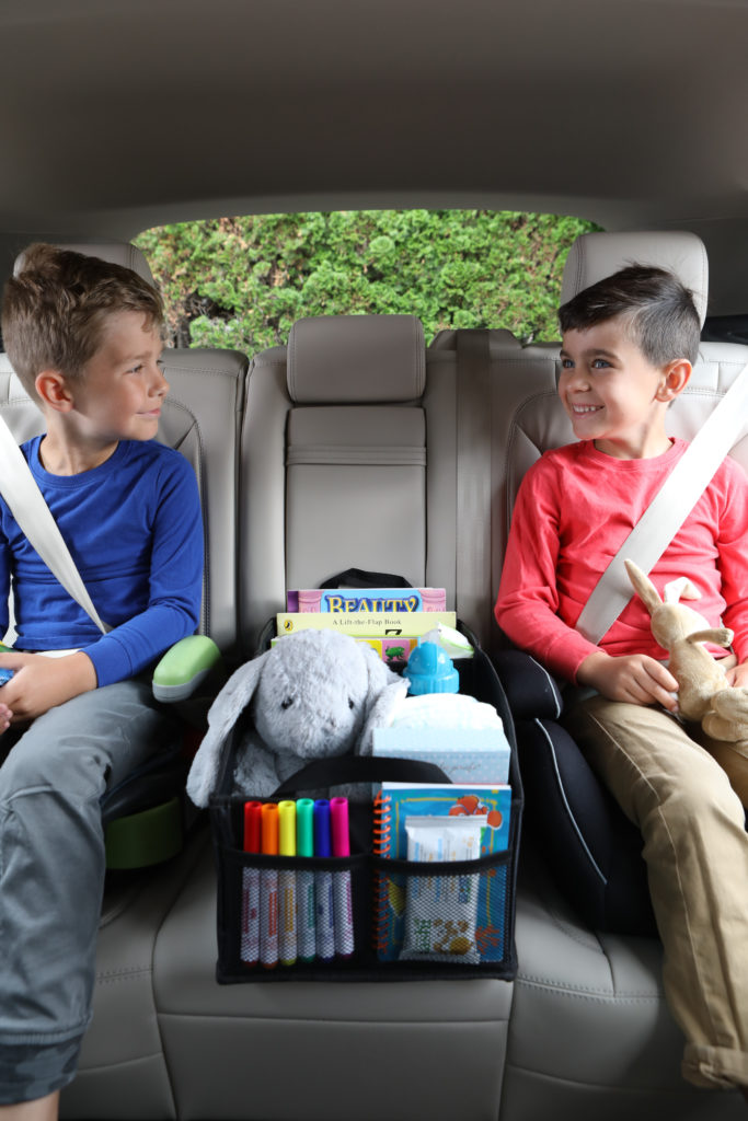 Lifestyle photo of 2 boys in a car with car toy box product