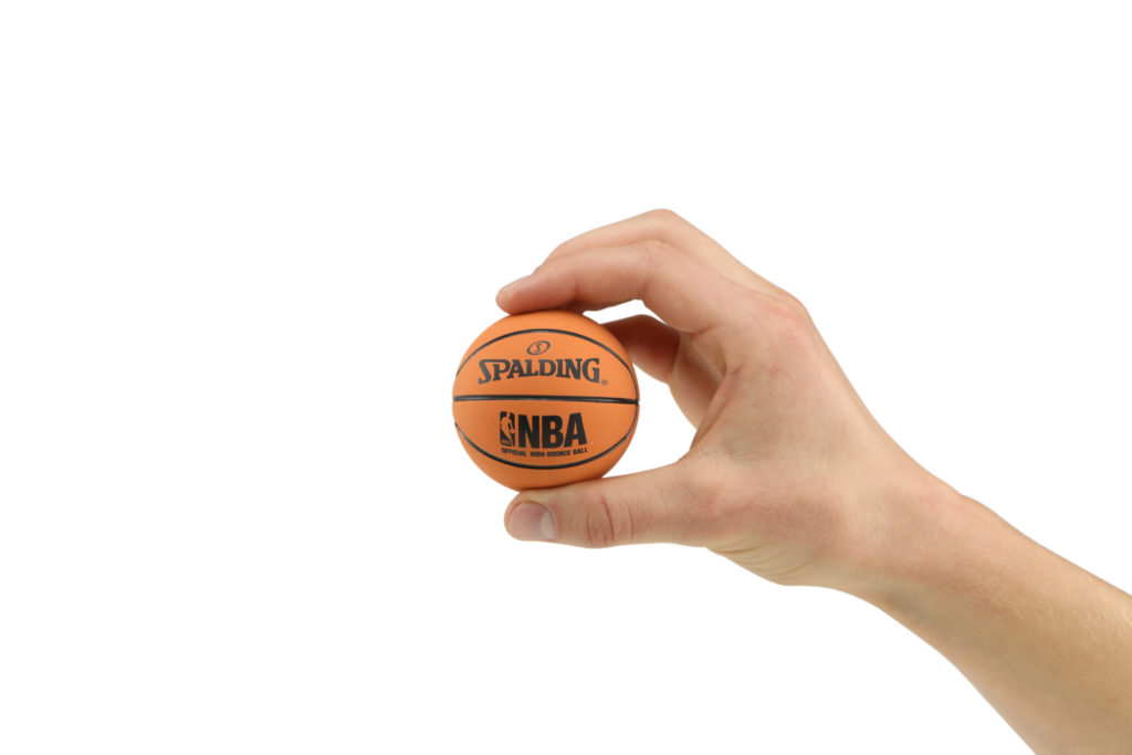 Hand model product photo on white background of hand holding a mini orange basket ball