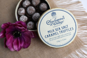 mini lifestyle photo of chocolates with purple flower and burlap tabletop product photograph