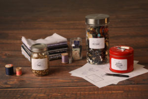 mini lifestyle photo of custom sewing labels with red can wooden tabletop product photograph
