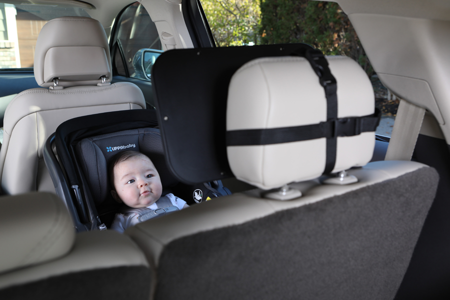 lifestyle photo of a baby in a car seat with baby car product