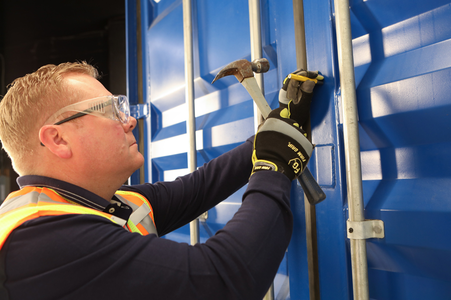 Lifestyle photo for guide book of man in yellow vest installing lock box