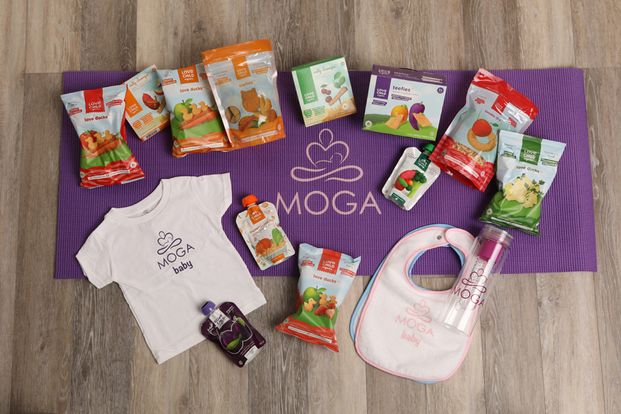 moga mini lifestyle photo of a purple yoga mat on wood floor with baby products