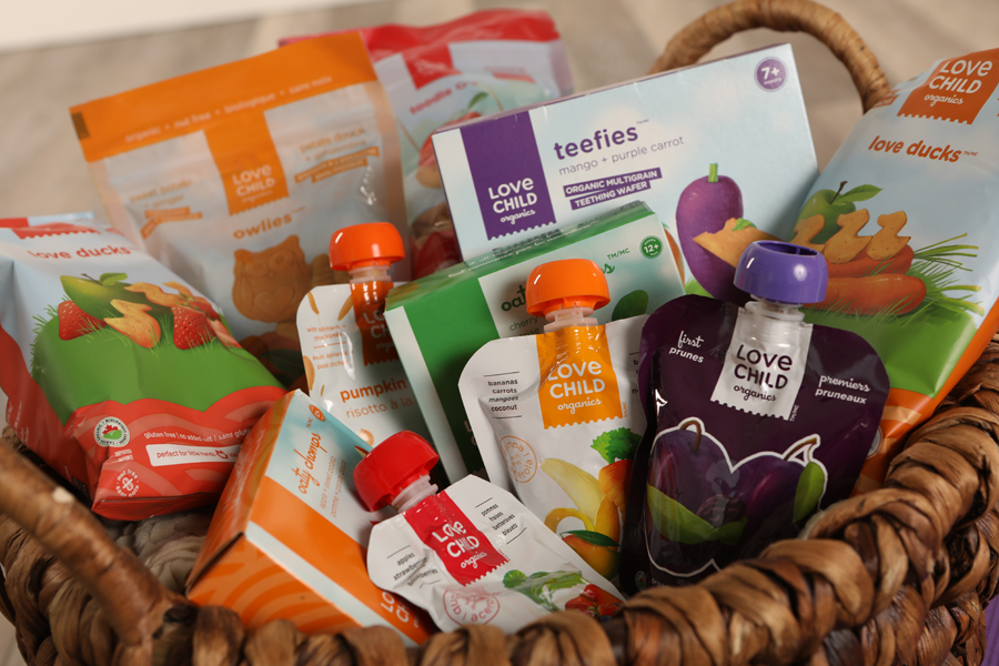 Mini lifestyle photo of basket of baby snacks and drinks